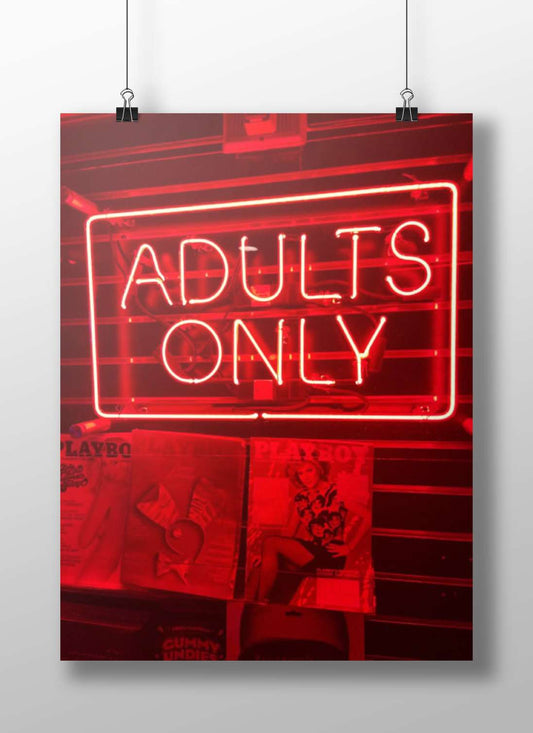 Red neon sign reading "ADULTS ONLY" mounted above PlayboY magazine covers Red Neon Adults Only