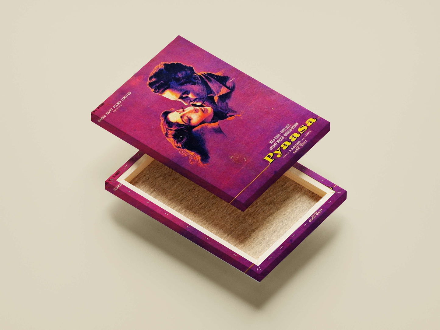 Open purple box with a colorful design on a beige background. Textured canvas wall art of Guru Dutt’s Pyaasa with deep violet and sunset hues, creating a premium gallery-style focal point in a modern home.