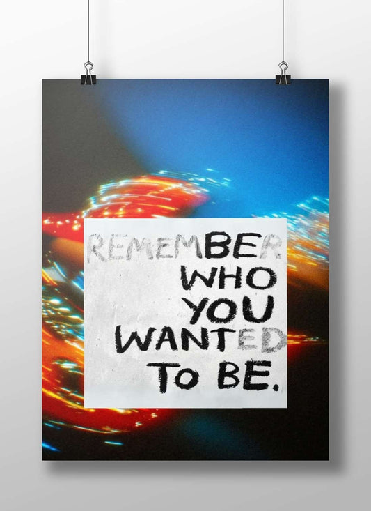 The motivational phrase "REMEMBER WHO YOU WANTED TO BE" in handwritten typography. Main Subject: The motivational phrase