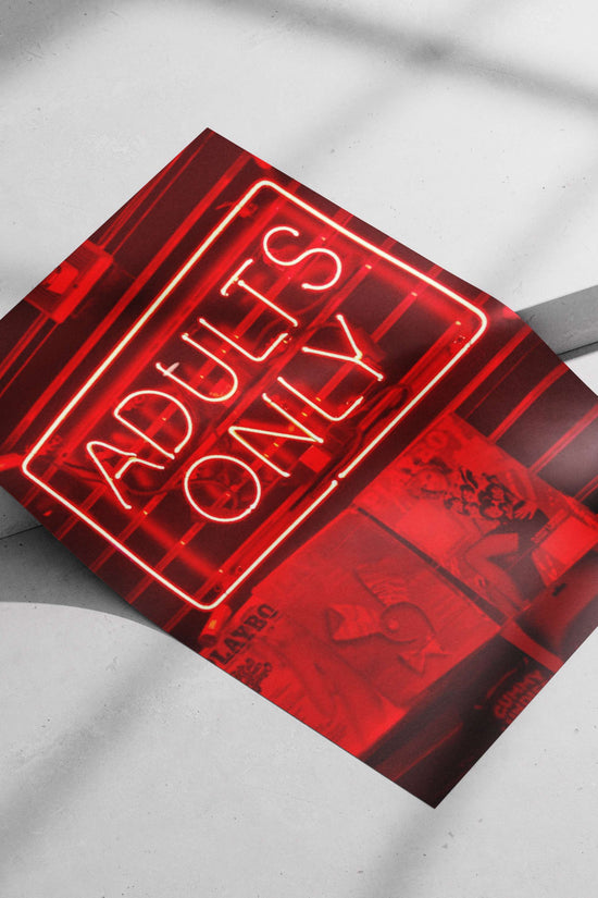 Red neon sign reading "ADULTS ONLY" mounted above PlayboY magazine covers Red Neon Adults Only