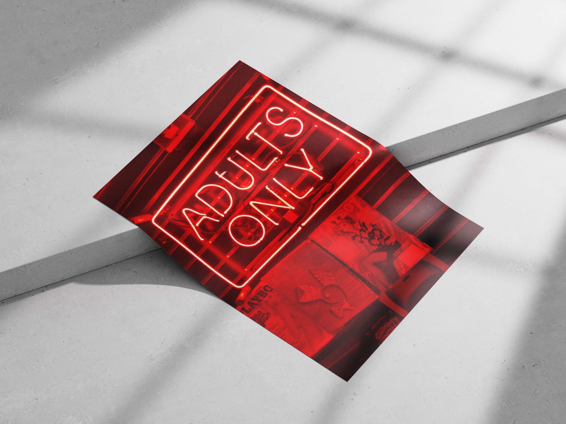Red neon sign reading "ADULTS ONLY" mounted above PlayboY magazine covers Red Neon Adults Only