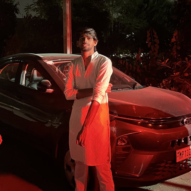 Person standing next to a car with a red tinted filter