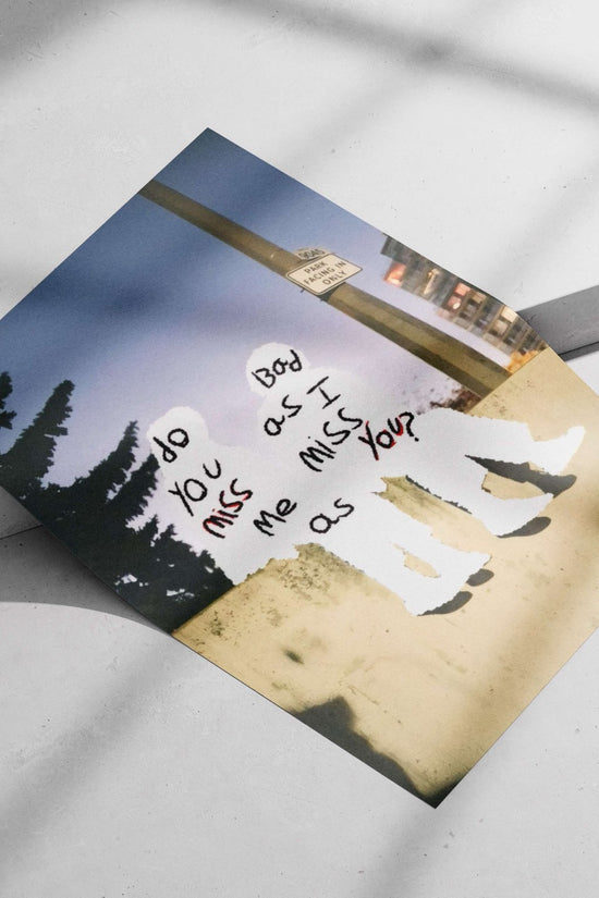 the phrase "do you miss me as I miss you?" written on two human silhouettes Main Subject: the phrase "do you miss me as I