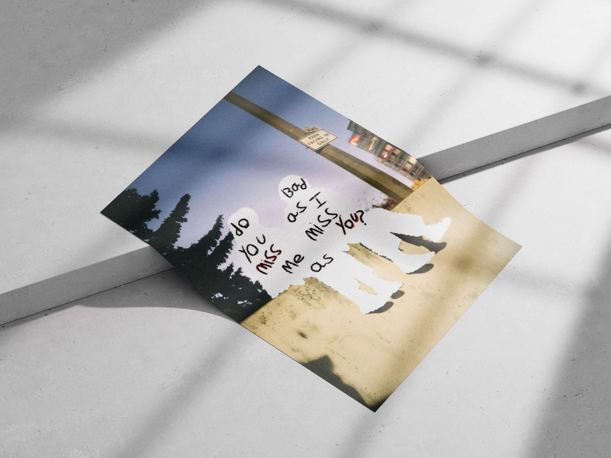 the phrase "do you miss me as I miss you?" written on two human silhouettes Main Subject: the phrase "do you miss me as I