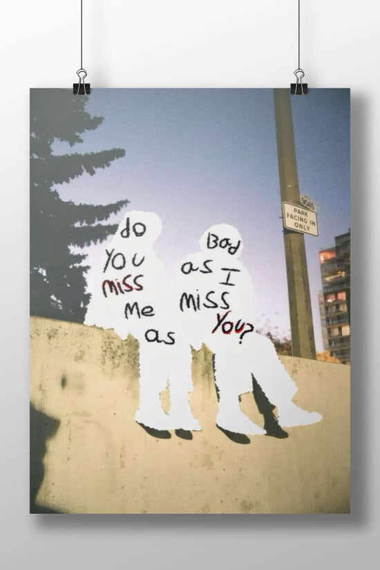 the phrase "do you miss me as I miss you?" written on two human silhouettes Main Subject: the phrase "do you miss me as I