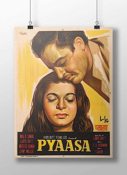 Vintage movie poster for 'Pyaasa' featuring a couple embracing with a yellow background. Rigid and durable Pyaasa Boizzboard featuring the iconic Guru Dutt and Waheeda Rehman lithograph, mounted frameless on a studio wall.