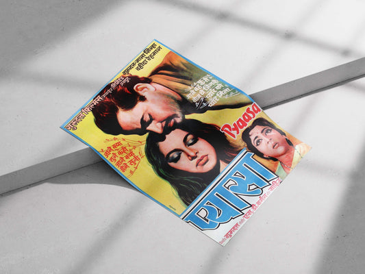 Vintage movie poster with two people on a gray surface.Vibrant Pyaasa movie poster with blue borders and Hindi lyrics, featuring Guru Dutt and Waheeda Rehman in a classic hand-painted style.