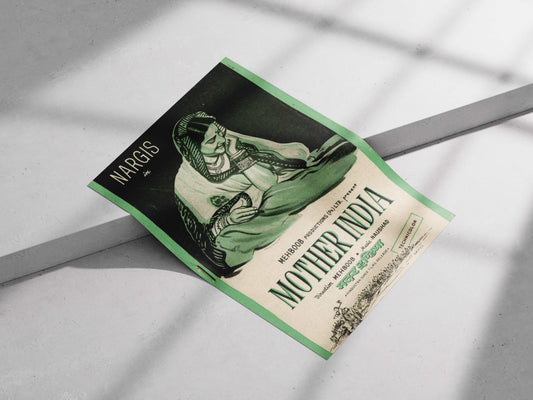 Book titled 'Mother India' by Nargis on a light gray surface with shadows. Vintage Mother India movie poster with Nargis in a green hand-drawn style, styled on a neutral cream-colored wall.