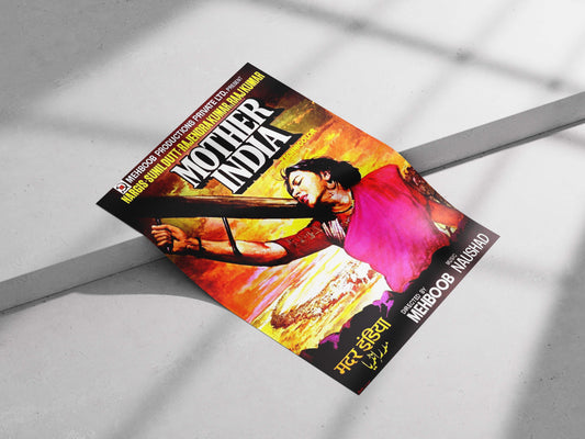 Colorful poster of 'Mother India' on a light gray surface. Bold technicolor Mother India movie poster with Nargis against a fiery sunset, styled in a modern industrial living room.