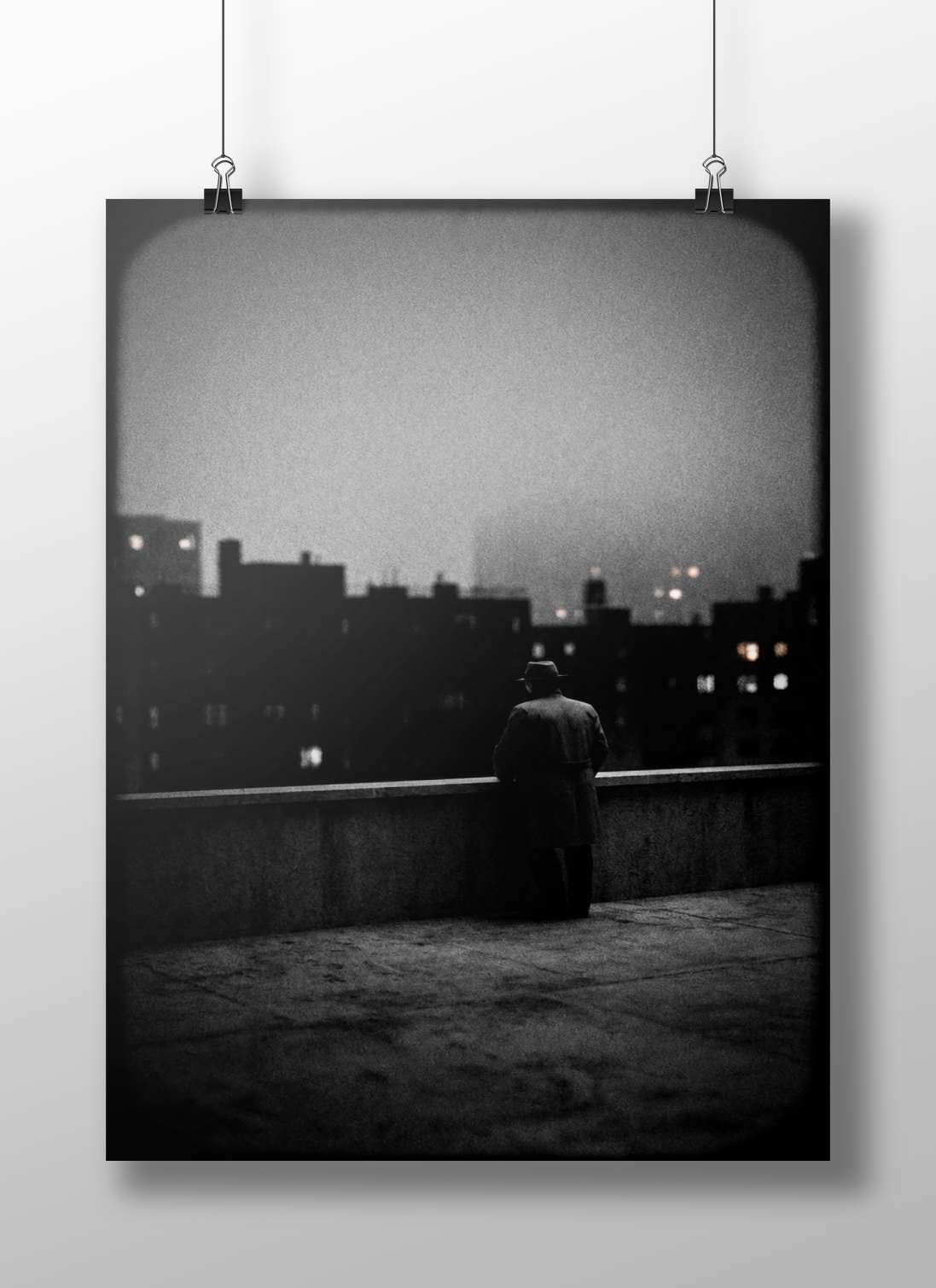 A lone man wearing a trench coat and fedora standing on a rooftop Main Subject: A lone man wearing a trench coat and fedora