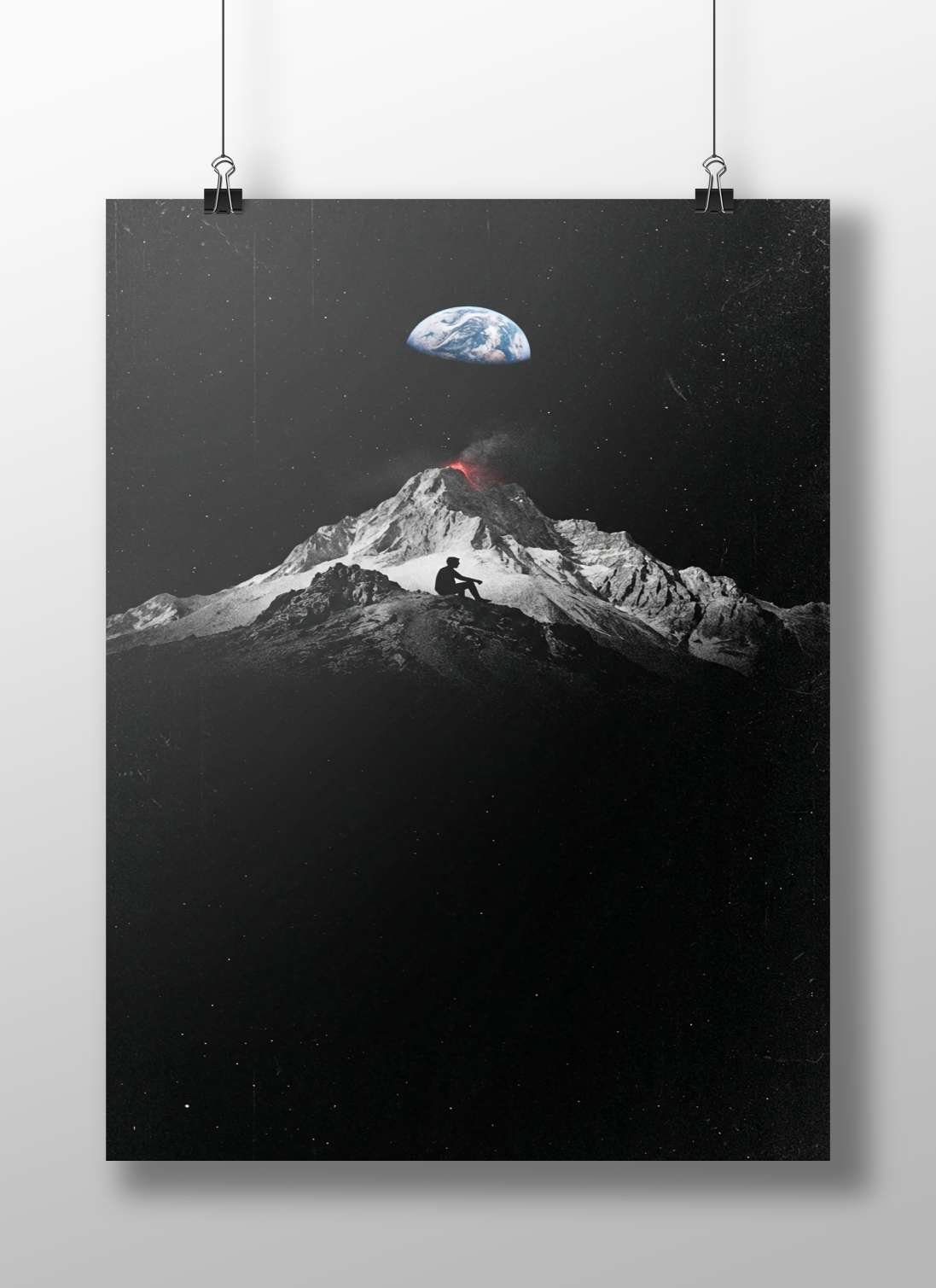 Human silhouette seated on a snow-capped volcanic mountain peak with Earth visible above in the night sky Main Subject: