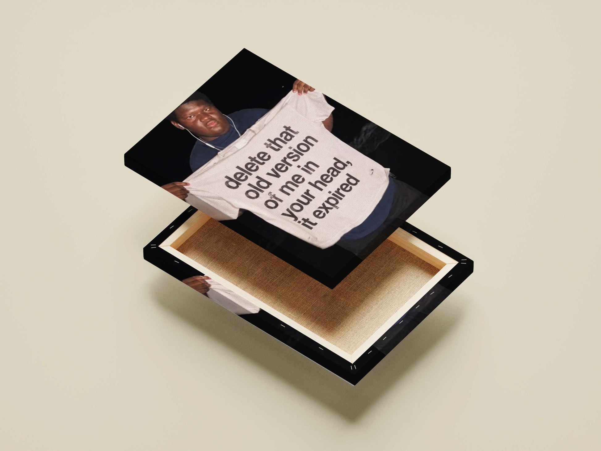 The phrase "delete that old version of me in your head, it expired" printed on a T-shirt. Main Subject: The phrase "delete