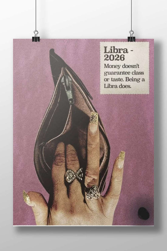 A human hand with gold glitter nail polish and bow-shaped rings positioned inside an open black stiletto heel, accompanied