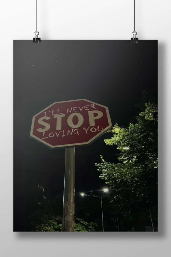 Stop sign modified with "I'LL NEVER STOP LOVING YOU" graffiti Main Subject: Stop sign modified with "I'LL NEVER STOP LOVING