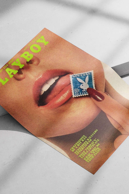 Close-up of a person's face with a hand holding a Playboy-branded stamp near the lips,