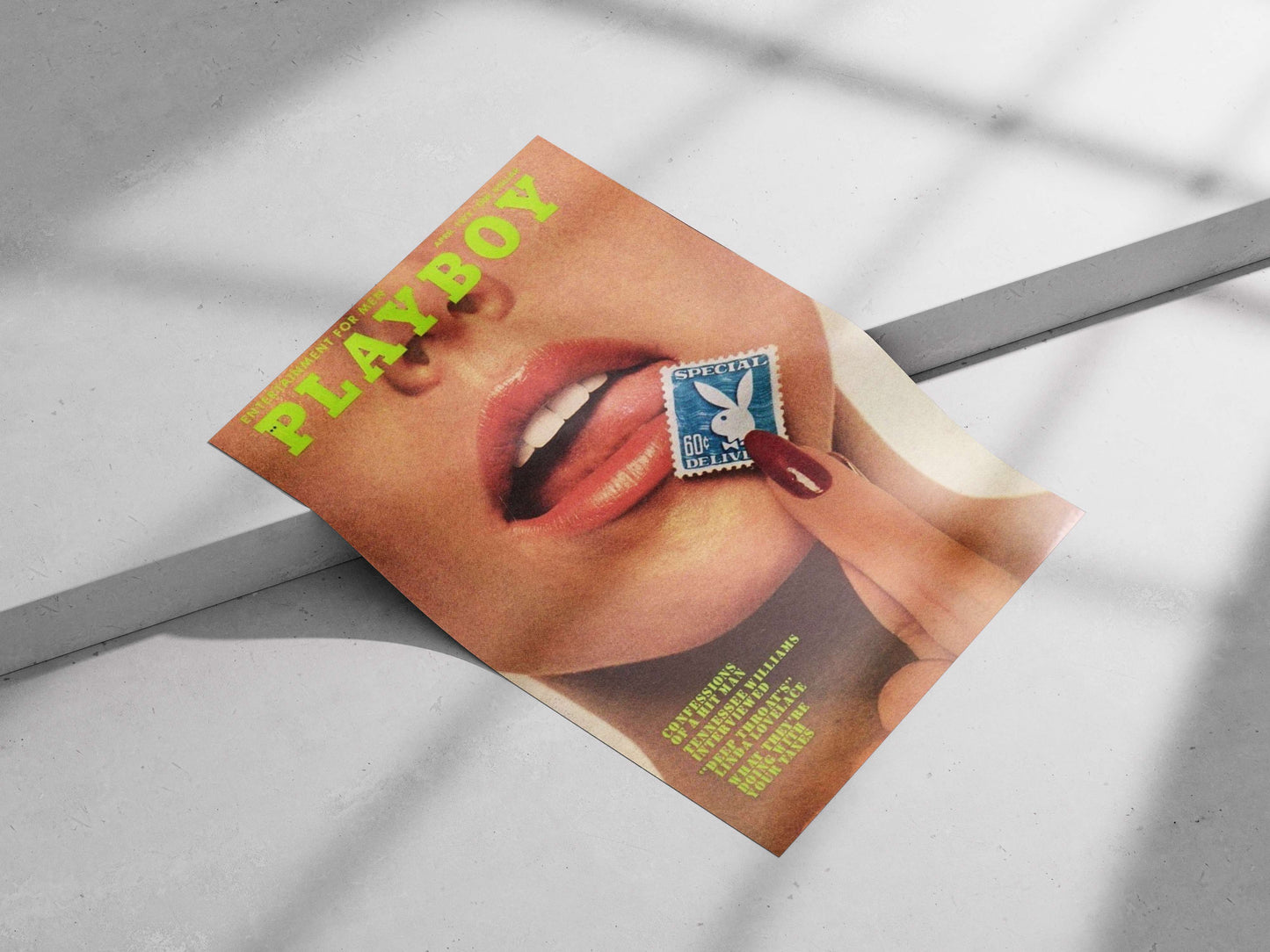 Close-up of a person's face with a hand holding a Playboy-branded stamp near the lips,