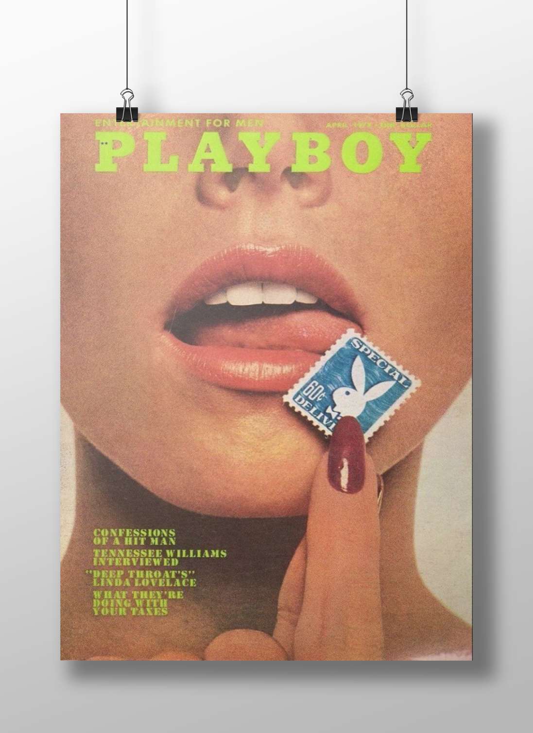 Close-up of a person's face with a hand holding a Playboy-branded stamp near the lips,