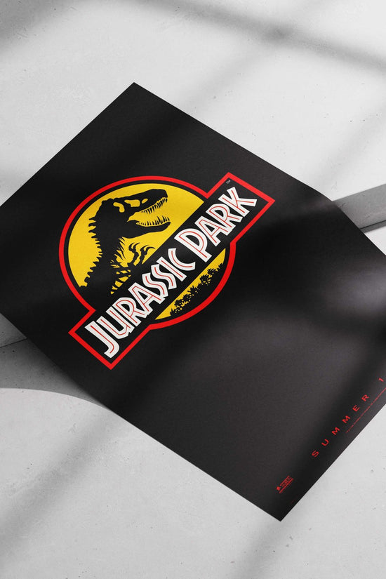 The Jurassic Park franchise logo, featuring a Tyrannosaurus Rex silhouette. Main Subject: The Jurassic Park franchise logo,