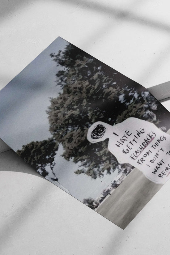 Human-shaped paper cutout with handwritten text about flashbacks Main Subject: Human-shaped paper cutout with handwritten